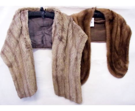 A brown mink stole together with another cream vintage fur stole