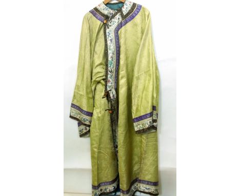 A Chinese yellow silk robe, the sleeves bordered with embroidery showing blossom and butterflies, with some gilt thread, the 