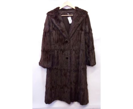 A vintage squirrel full length coat, trimmed with large buttons to sleeve and front and a half belt 