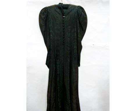 An Edwardian black watered silk coat, leg of mutton sleeves and button and loop fastenings 