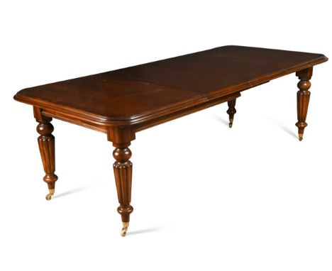 A Victorian style mahogany extending dining table, 20th century, with two additional leaves, the rounded rectangular top abov