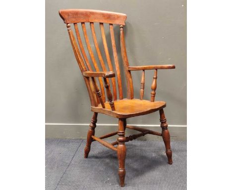 A Windsor style comb-back armchair on turned legs