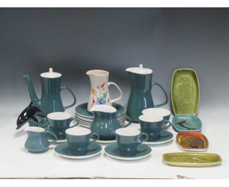 A collection of Poole Ware to include four cups, a milk jug, a coffee pot, a hot water pot, plates, a dolphin etc.