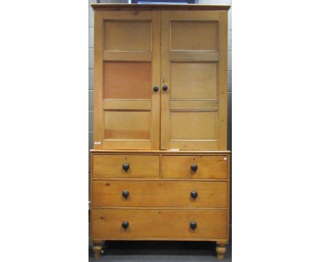 A pine dresser with ebony handles, the wardrobe top section upon the lower section of two short drawers over two long, 224 x 