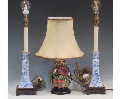 A mid-20th century Moorcroft table lamp together with two blue and white ceramic table lamps (3)