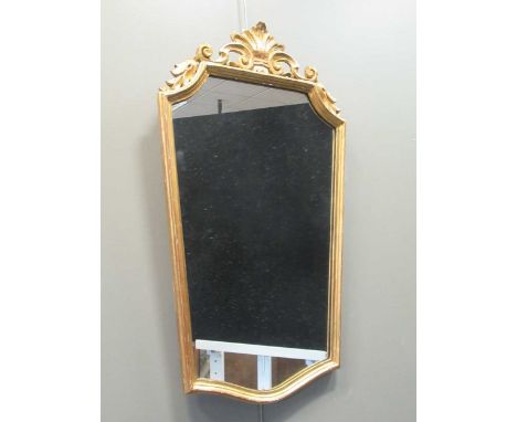 A carved giltwood wall mirror surmounted by a shell and S-scrolls, 92 x 52cm; together with a 20th century mahogany chest of 