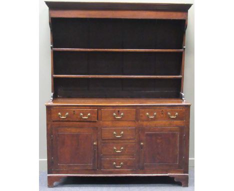 A late 18th century Welsh oak dresser, the boarded plate rack above a lower section comprising of six drawers and two cupboar