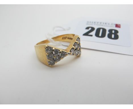 An 18ct Gold Diamond Set Ring, of stylised bow design, set throughout with brilliant cut stones (finger size L) (5.7grams). 