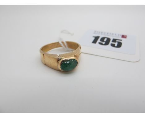 A Single Stone Ring, oval cabochon set, indistinctly stamped "18k" (finger size K1/2). 