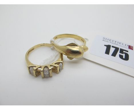 A Dolphin Ring, stamped "585" (finger size Q); A Five Stone Dress Ring, (stones missing) stamped "585" (finger size N) (total