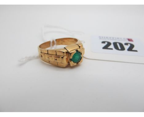 An Emerald Single Stone Ring, circular set between geometric design shoulders, indistinctly stamped "18k" (finger size M). 