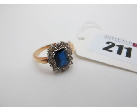 A Diamond Cluster Ring, claw set throughout, indistinctly stamped "18" (finger size Q). 