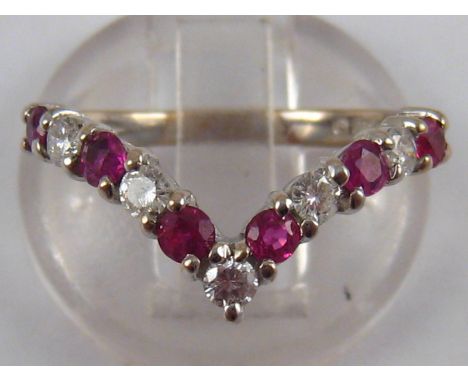 An 18 carat white gold ruby and diamond “wishbone” ring, the stones of good colour measuring approx. 2.5mm diameter, size O, 