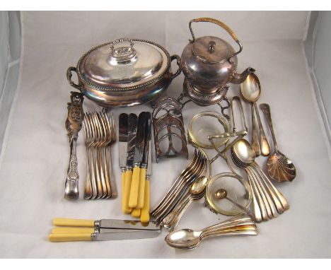 Silver plate. An oval tureen with scroll feet, a tea kettle on burner stand with lamp, a toastrack, serving tongs etc. and a 