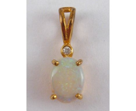 A yellow metal (tests 18 carat gold) opal and diamond pendant, opal approx. 7.5 x 6mm, 0.8 gms.
