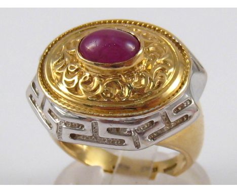 A yellow amd white metal (tests 18 carat gold) cabochon ruby ring, ruby approx. 8 x 5.5mm, ring size O, 14.7 gms.
