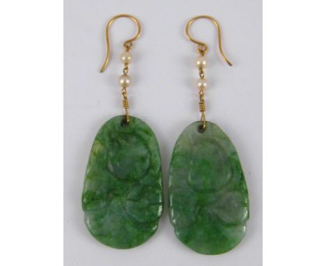 A pair of carved jade and seed pearl earrings with gold wire fittings, approx. 7cm drop.