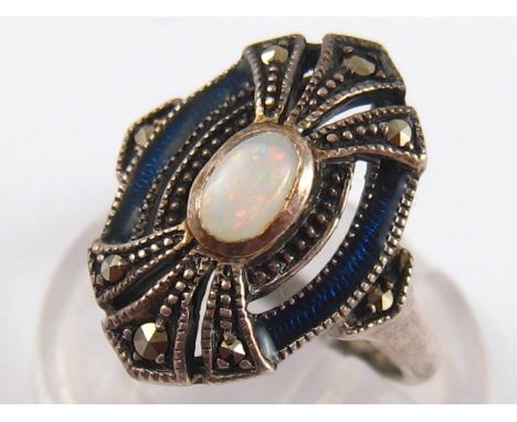 An unusual white metal (tests silver) opal and blue enamel ring, opal approx 5 x 3.5mm, ring size I.
