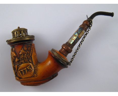 A German meerschaum pipe , the bowl carved as a wolf by a cottage, with date 1775, stormguard cover, maker's mark JH, and nac