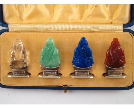 A fine set of four silver and carved gemstone menu holders, London import hallmarks for 1930, sponsors mark C&C, carved as Bu