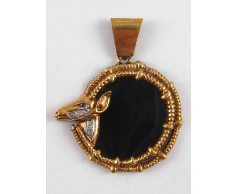 A yellow metal (tests 9 carat gold) onyx, diamond and ruby pendant, approx. 4.5cm wide, 11.6 gms.

