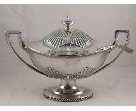 A large two handled silver plated soup tureen in the Adam style, the oval body and lid part ribbed, also a ladle. 20x36cm. 