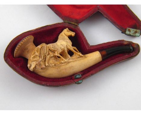 A carved meerschaum pipe with amber mouthpiece, approx. 9cm long, in fitted case marked J.H.Thiry -Nyst, Maastricht.
