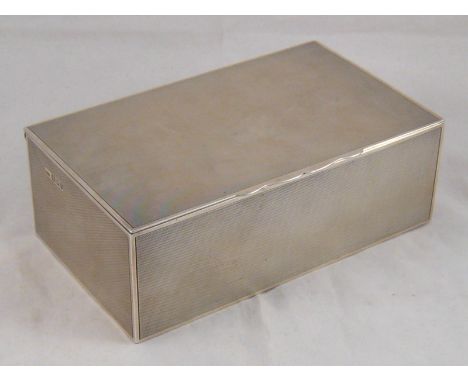 A silver cigarette box with engine turned finish, London, 1938. wt. 751gm. 