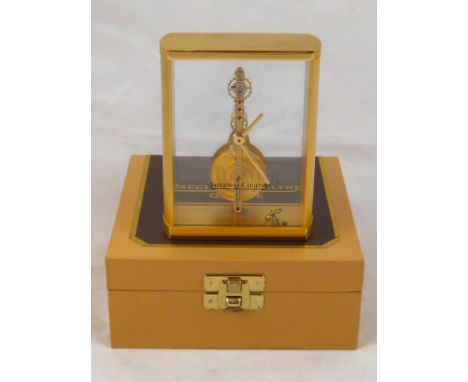A Jaeger le Coultre brushed gilt and glass, visible movement, mantel clock. (AF- dislodged cog needs resetting). In Jaeger ca