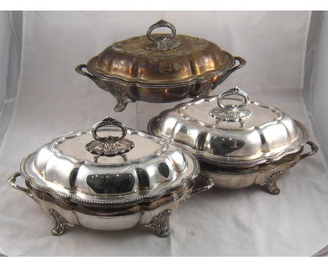 A pair of Old Sheffield Plate chafing dishes of shaped oval form with beaded edges , crests and armorials, having separate he