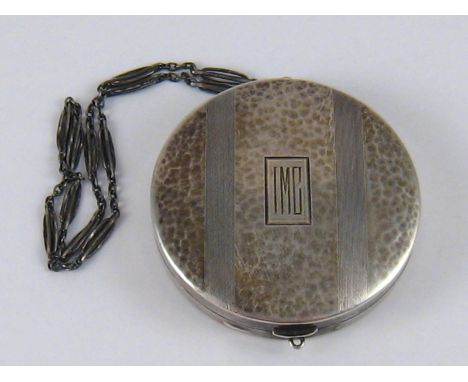 A lady's silver compact, marked sterling, with part hammered, part engine turned finish containing a sovereign coin compartme
