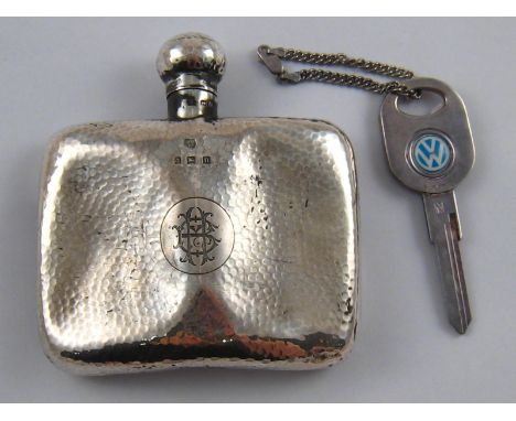 A silver hip flask with hammered finish, Birmingham, 1912. (AF), together with a silver chain and Yale type key with Volkswag