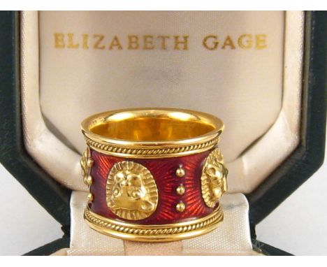 An 18 carat gold and red enamel ring by Elizabeth Gage, stamped GAGE and EG, approx. 16mm wide, 15.8 gms, in original case.
