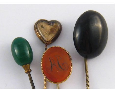 A mixed lot comprising three stick pins (two antique) and a hat pin.
