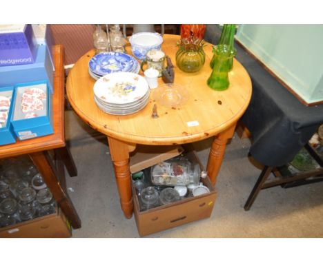 A modern pine circular top kitchen table