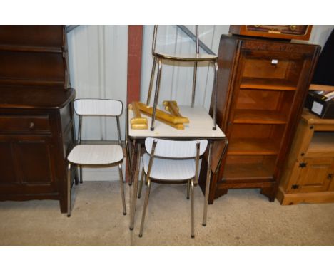 A formica top drop leaf kitchen table with three chairs