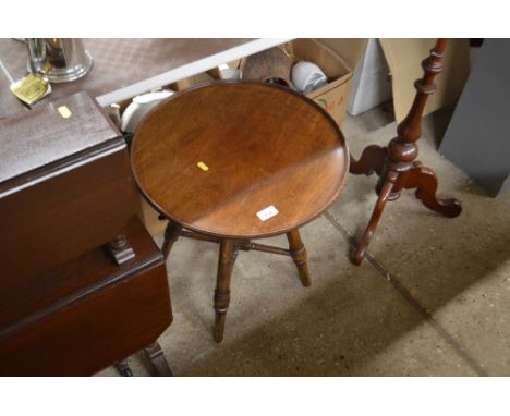 A mahogany circular top table