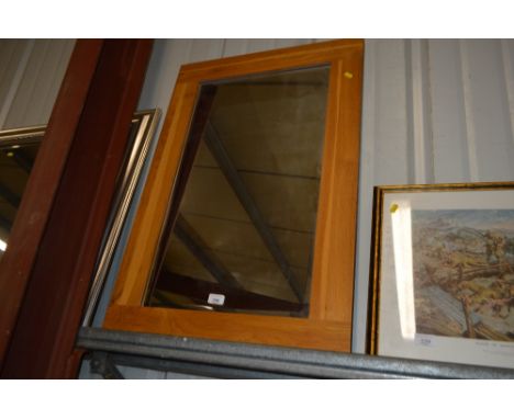 A light oak framed mirror