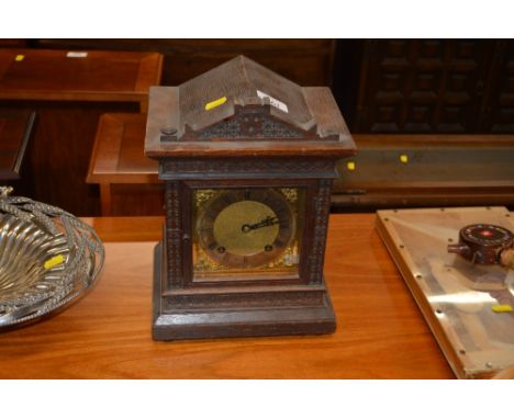 An oak cased two hole mantel clock of architectural form