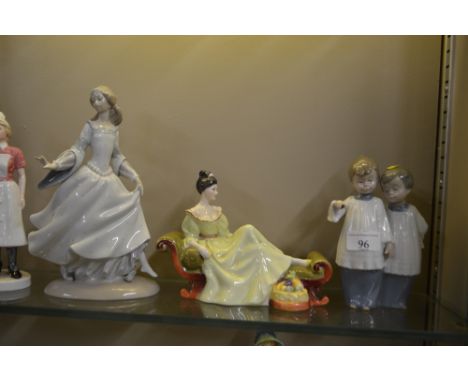 A Royal Doulton figurine"At Ease"; a Lladro figurine AF; a Nao figure group of two choir boys