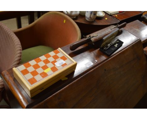 An Eastern carving set; a travelling chess set and a pipe tool
