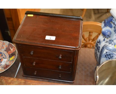 A Victorian mahogany three drawer dressing table tidy