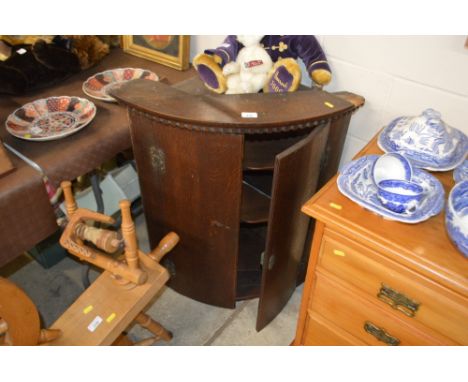 A Georgian oak bow front hanging corner cupboard