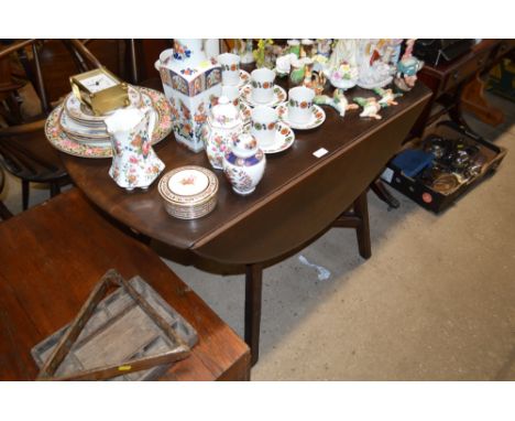 An Ercol drop leaf kitchen table and a set of four carver chairs