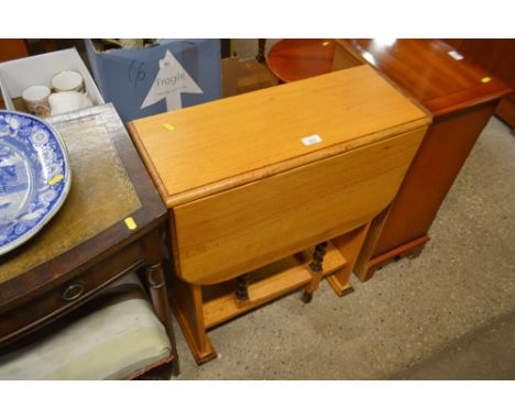 A light oak drop leaf table