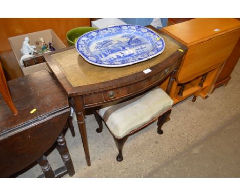 A reproduction mahogany bow front writing table and a dressing stool