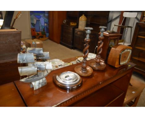 Two mantel clocks; a pair of oak barley twist candlesticks; a barometer and a carved horn ornament in the form of a ship