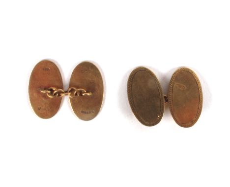 A pair of Irish 9ct yellow gold cufflinks. The flat oval links with engine-turned border, joined by chain, hallmarked for Dub