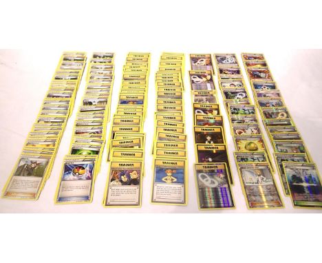 Collection of assorted Trainer Pokemon trading cards including shiny examples; Chaos Tower 94/124, Charizard Spirit Link 75/1