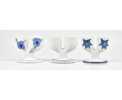 TROIKA POTTERY; three double egg cups, to include an unusual example with floral decoration, each with rubber stamp marks to 